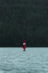 A boat with a cross on it is in the water