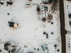 An aerial view of a snow covered parking lot
