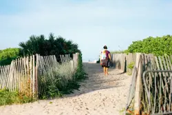 Woman in red top near white fence