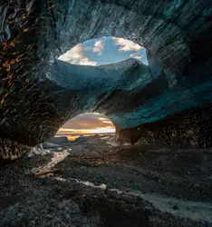 Gray stone cave during golden hour