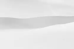 A man riding skis down a snow covered slope