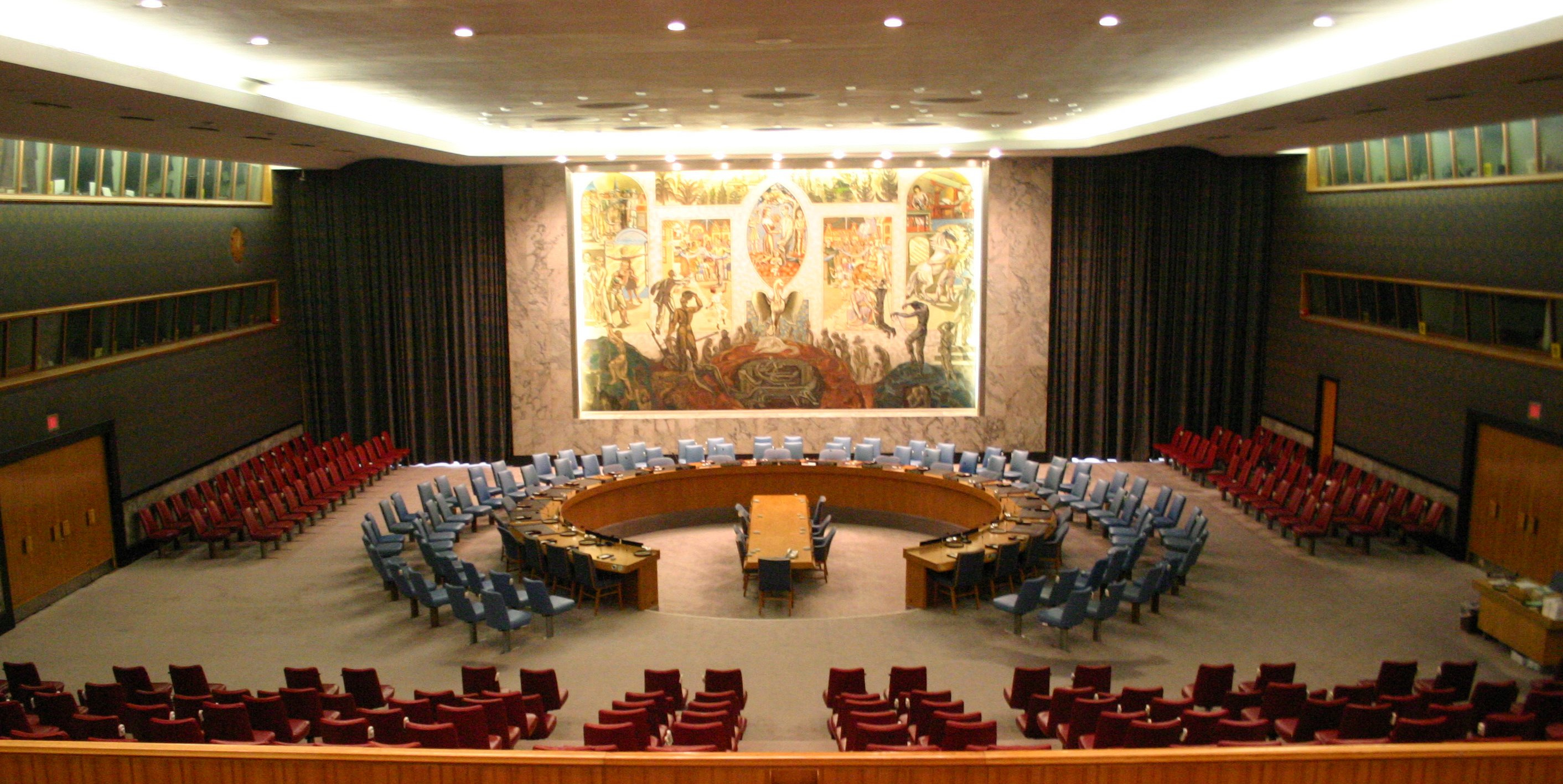 Room With A Large White Table And A Large Blue Wall