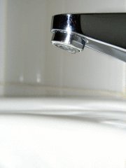 Glass Sink With A Tooth Brush In It