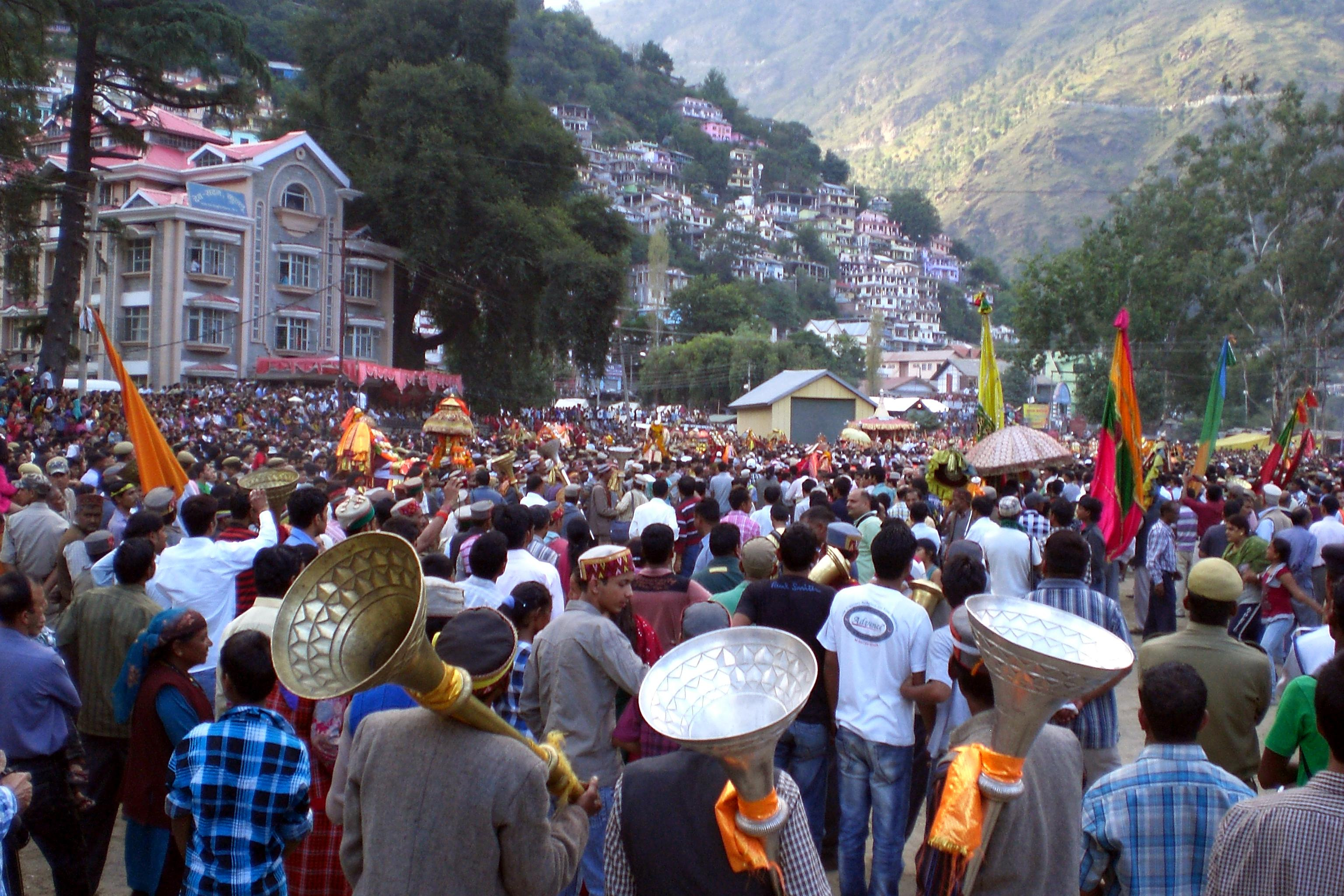 Crowd Of People Standing On A Street With A Large Group Of People Holding Flags