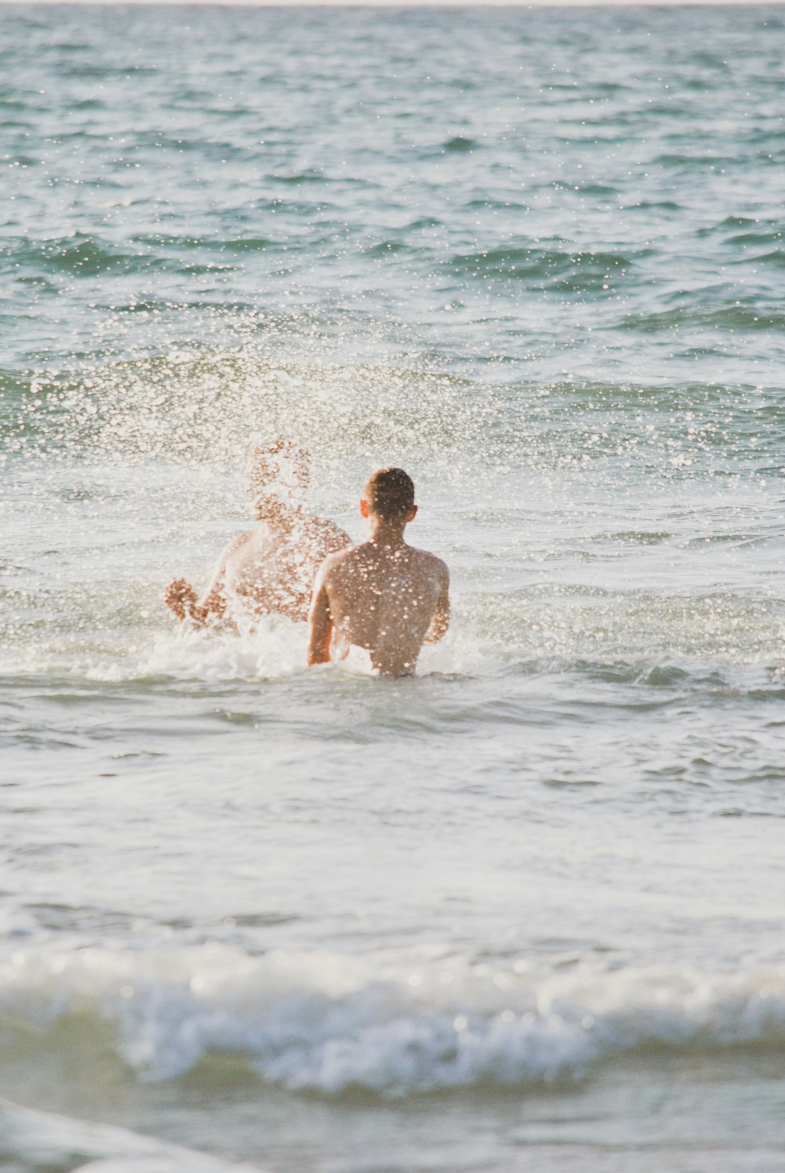 Man Is In The Water On A Surfboard