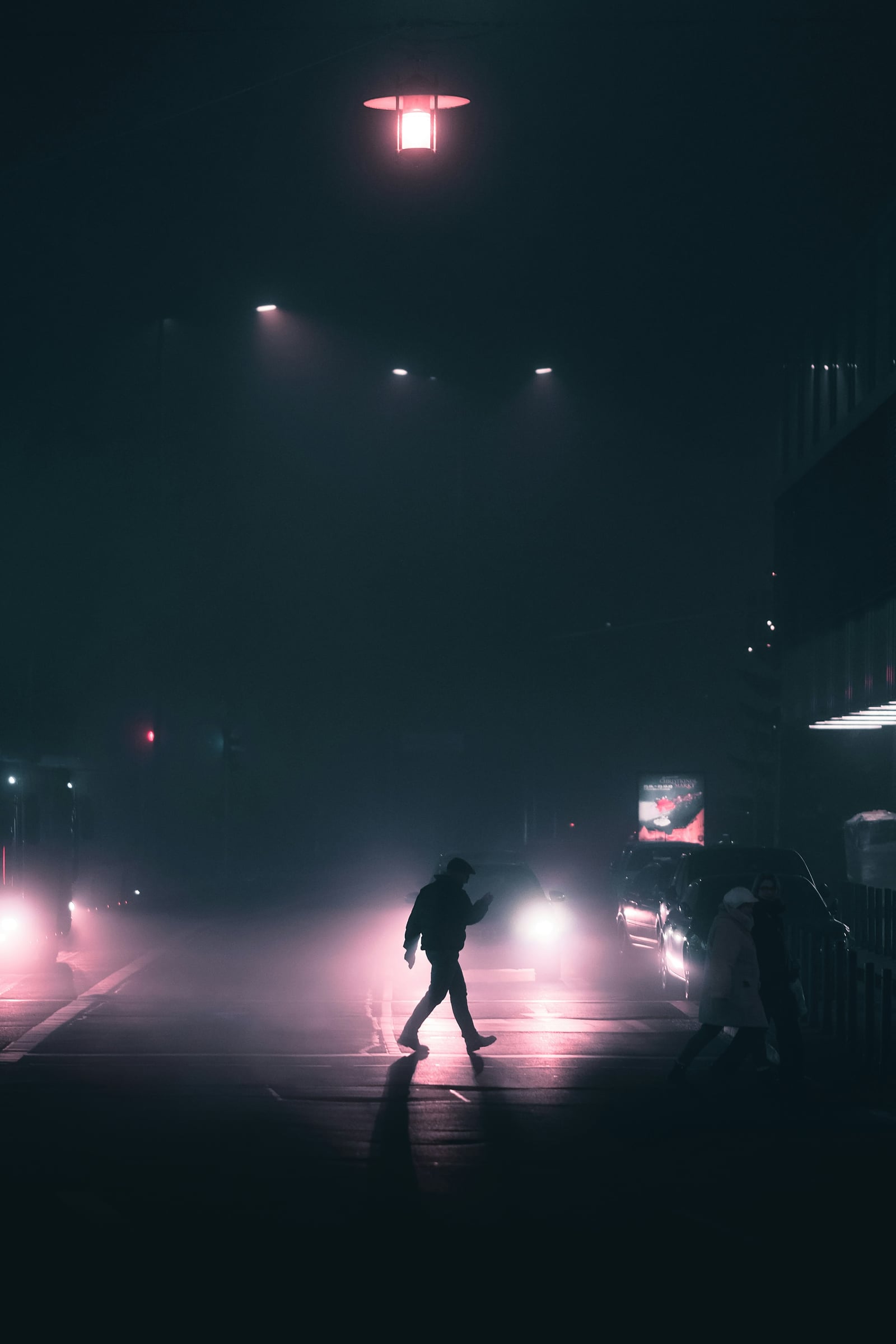 Person Walking Down A Street At Night